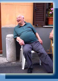 Mariano Luchini sits outside his home in Cagli