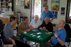 After a round of Bocce, the men relax with games of pinochle.