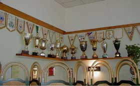 A corner of the bar room overflows with awards won by past <I>Cagliesi Bocce</I> teams.
