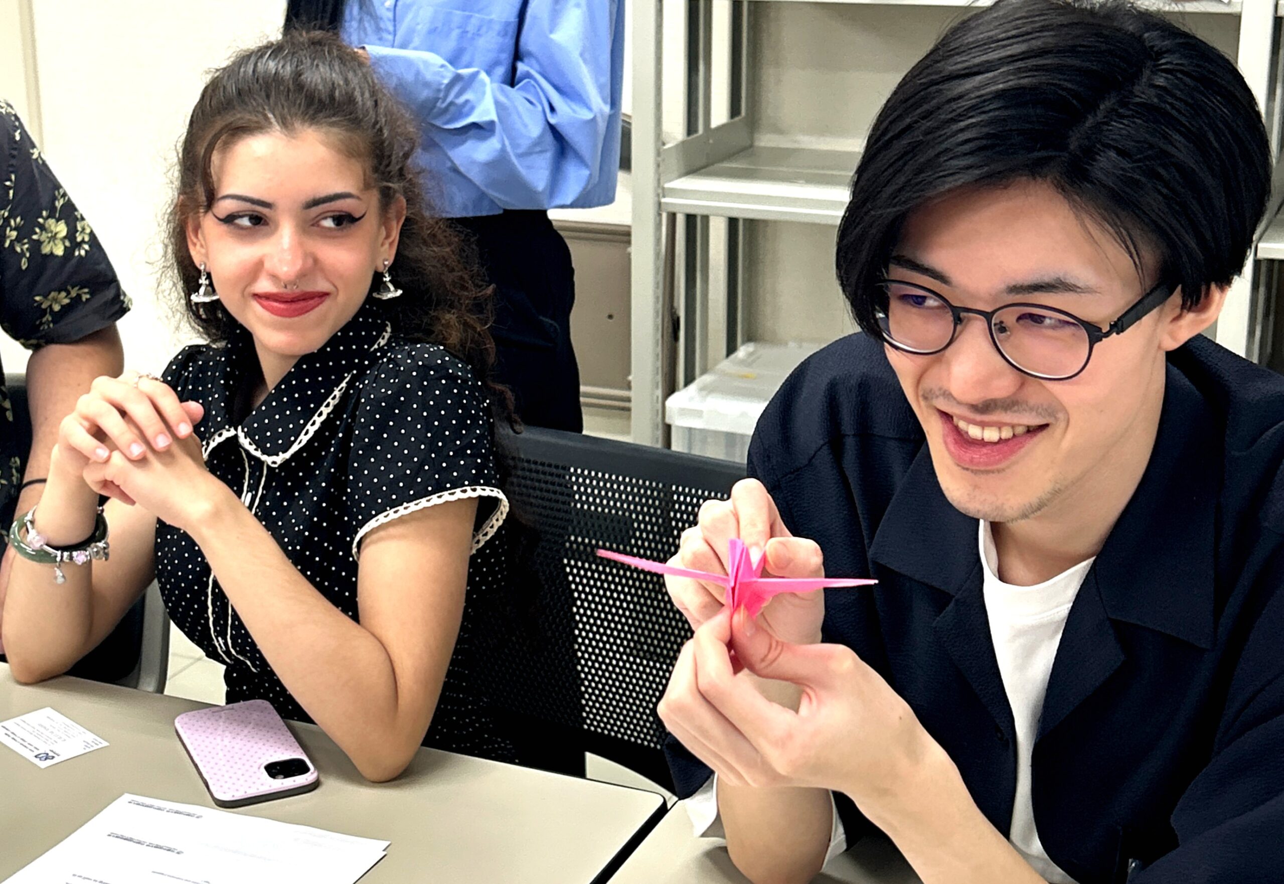 Two students practice Japanese origami together.