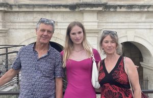 host family couple with their exchange student on the Arles study abroad program