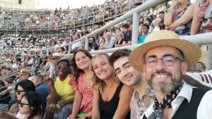 study abroad students sitting in the arena at a bull games event with a host family